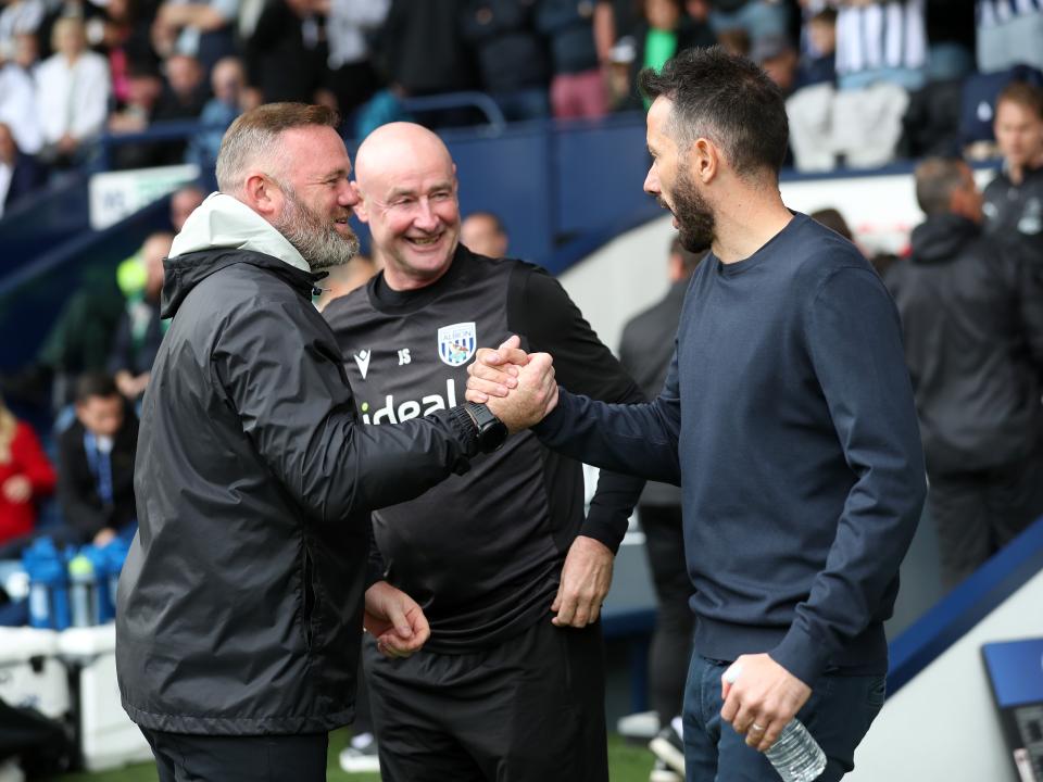 Wayne Rooney and Carlos Corberán shake hands at the side of the pitch at The Hawthorns 