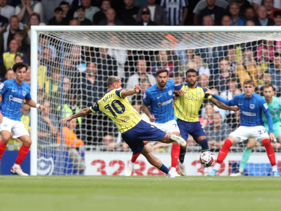 Albion in action against Portsmouth at Fratton Park, in yellow and blue away colours.