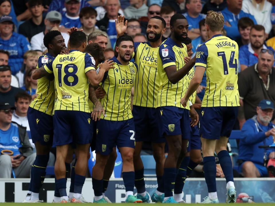 Albion in action against Portsmouth at Fratton Park, in yellow and blue away colours.