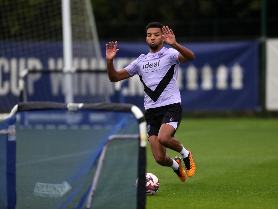 Mason Holgate sliding to reach a ball in front of a mini goal on the training pitch 
