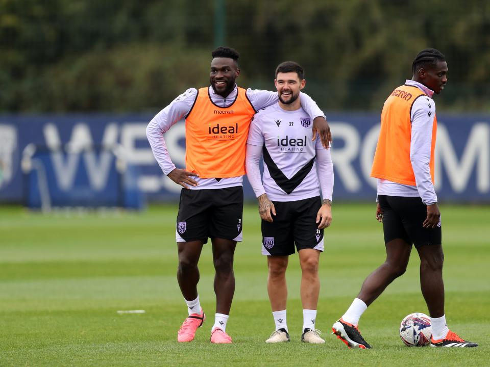 Daryl Dike with his arm around Alex Mowatt during training with both players smiling 