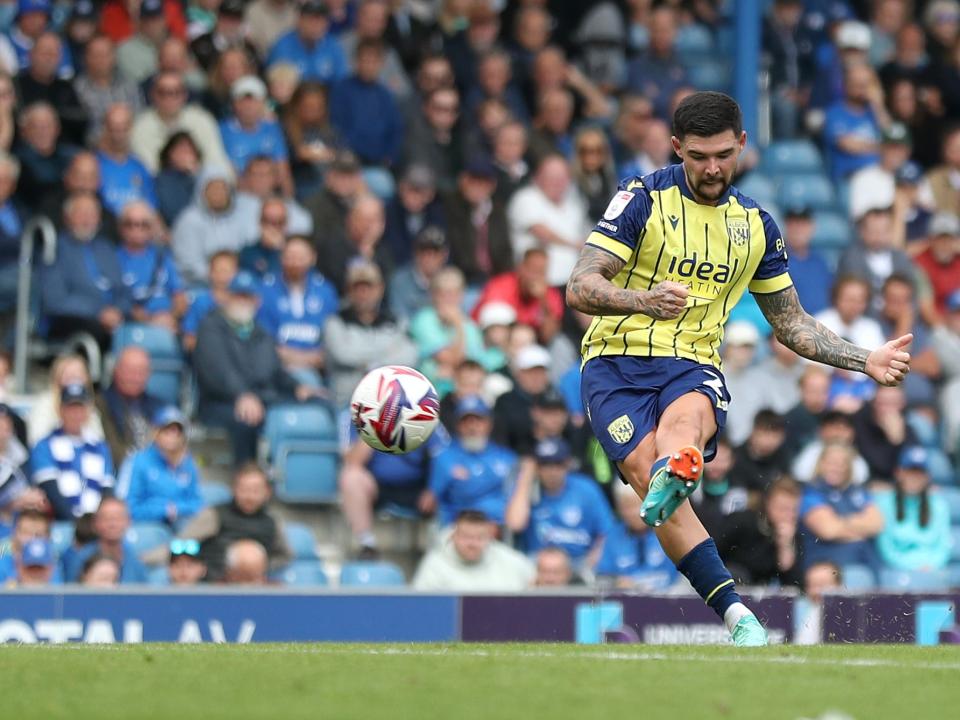 Albion in action against Portsmouth at Fratton Park, in yellow and blue away colours.