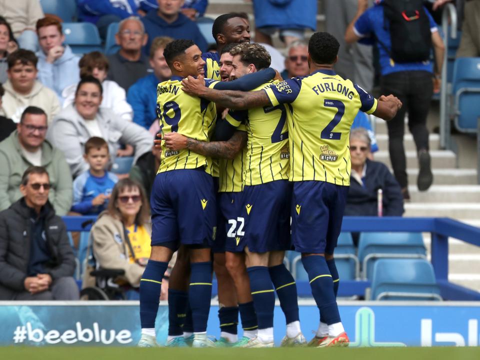 Albion in action against Portsmouth at Fratton Park, in yellow and blue away colours.