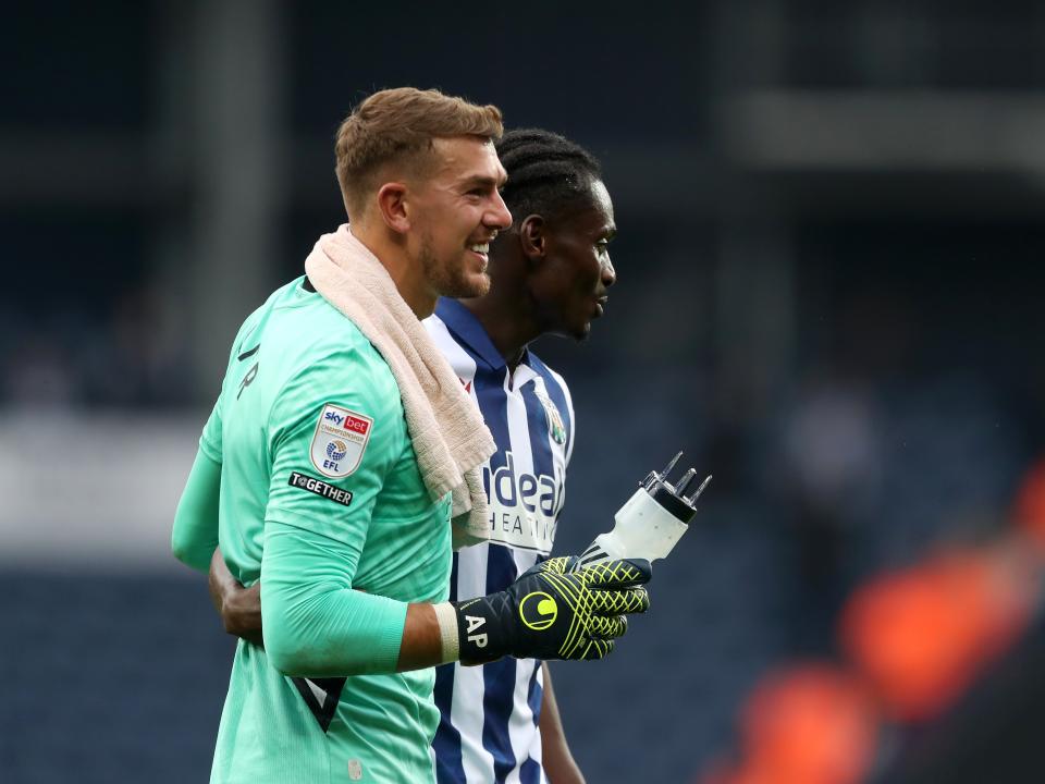 Alex Palmer and Ousmane Diakité embrace at full-time against Plymouth 
