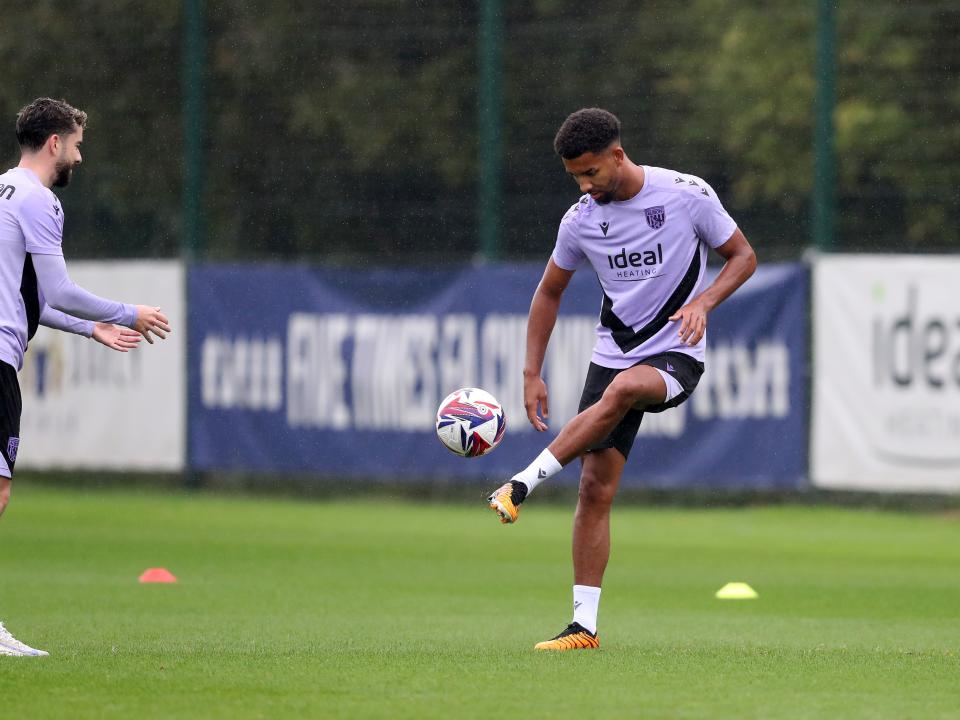 Mason Holgate passes a ball back to Mikey Johnston out on the training pitch 