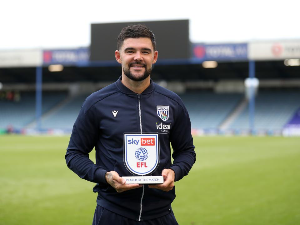 Albion in action against Portsmouth at Fratton Park, in yellow and blue away colours.