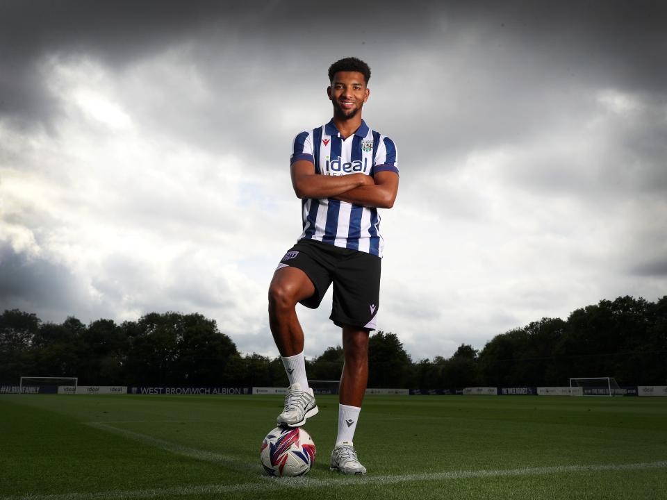 Mason Holgate stood on a training pitch in the home shirt with one foot on the ball and his arms crossed