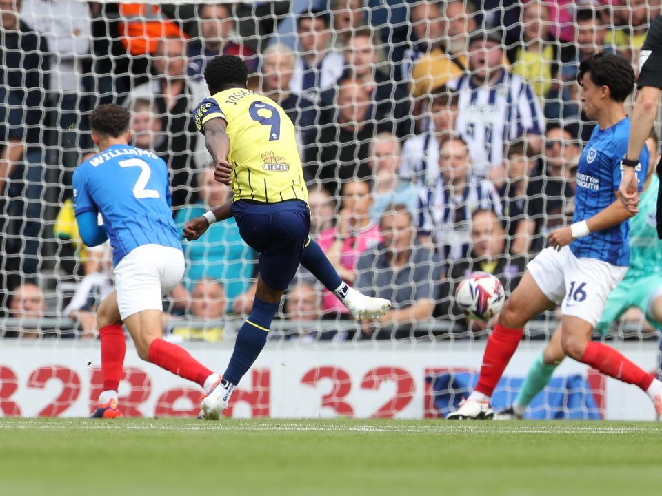 Albion in action against Portsmouth at Fratton Park, in yellow and blue away colours.