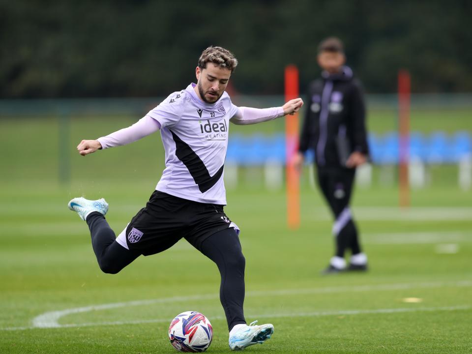 Mikey Johnston strikes at goal during a training session 