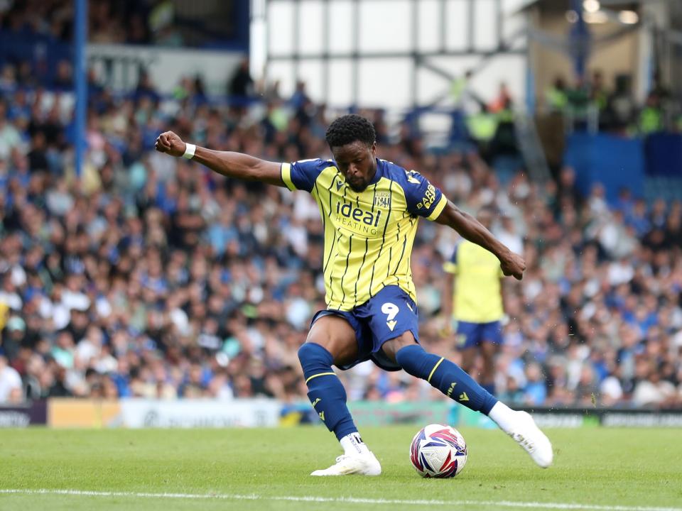 Albion in action against Portsmouth at Fratton Park, in yellow and blue away colours.