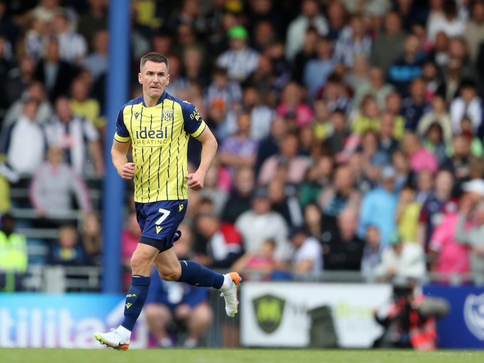 Albion in action against Portsmouth at Fratton Park, in yellow and blue away colours.