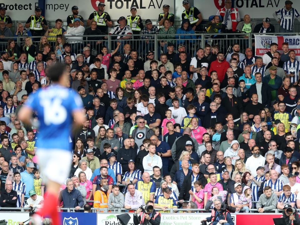 Albion in action against Portsmouth at Fratton Park, in yellow and blue away colours.