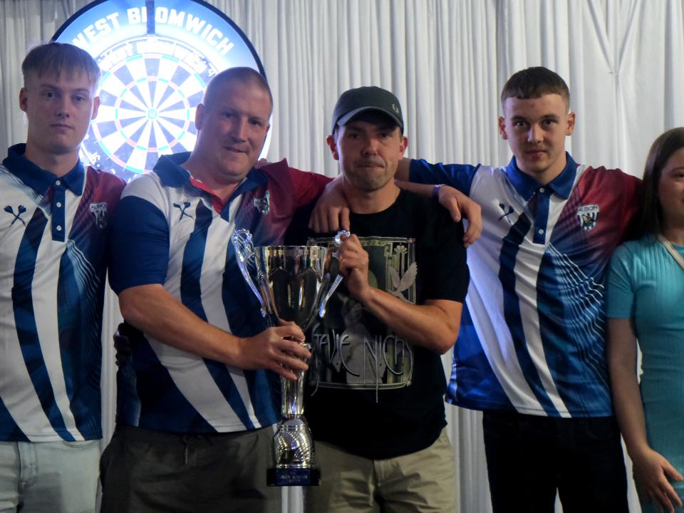 Richard Swallows and his family holding the Squalla Cup.