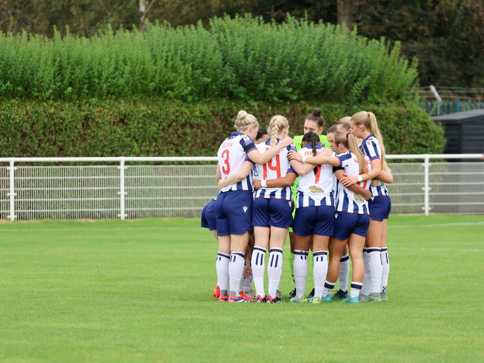 Albion Women in a team huddle.