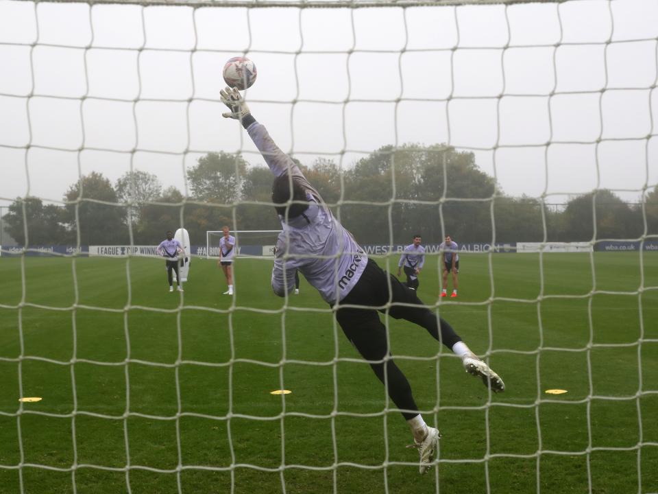 Alex Palmer making a diving save during training 