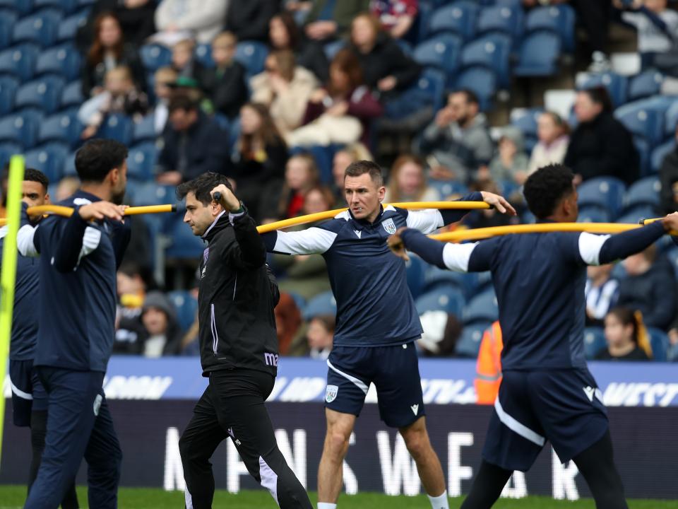 Several Albion players warming up before a training session at The Hawthorns