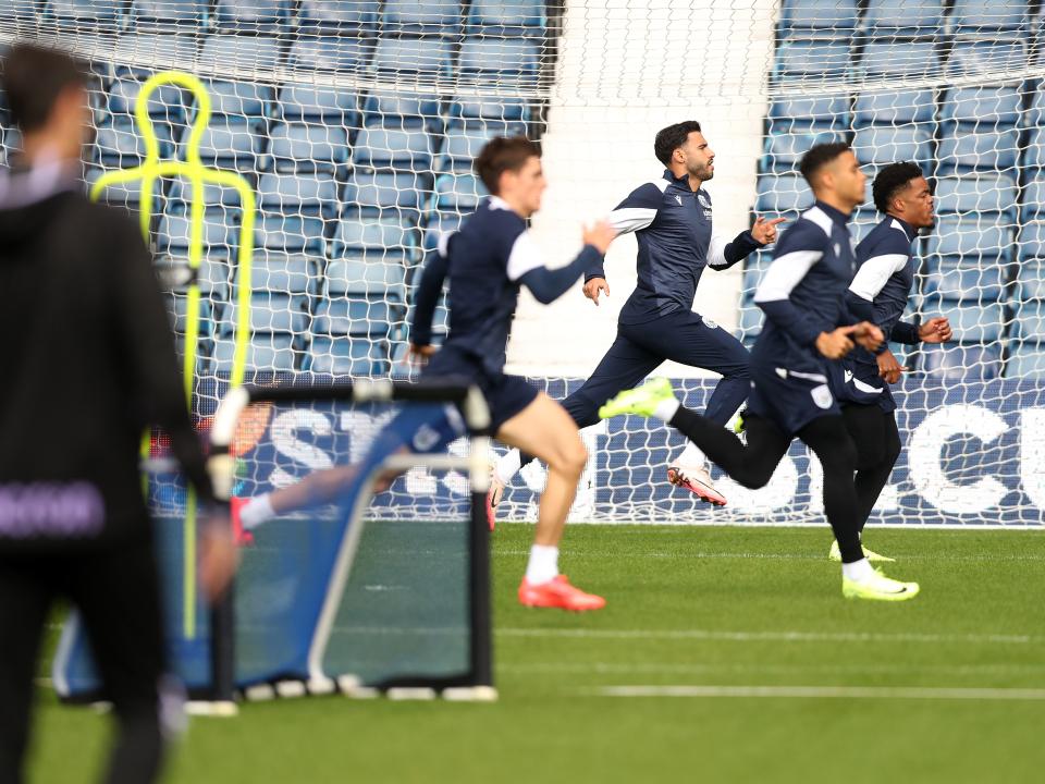 Several Albion players warming up before a training session at The Hawthorns