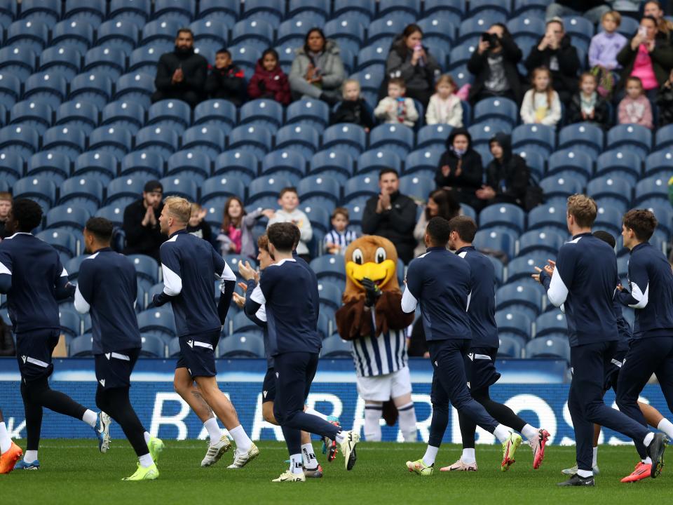 Albion players applaud fans in the stands on open training day