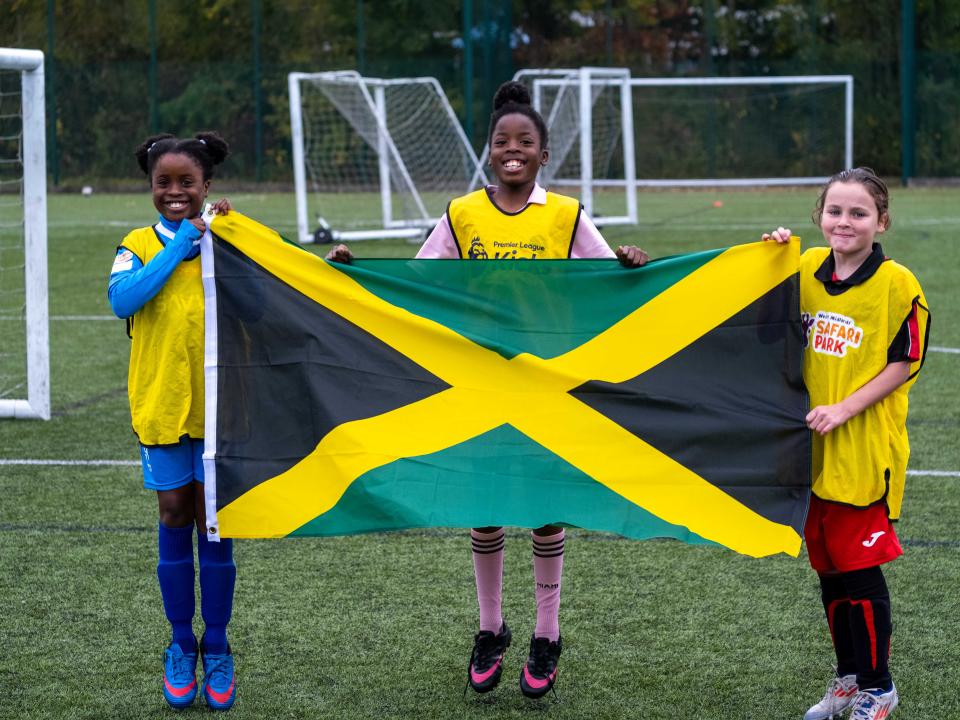 Three PL Kicks participants with the Jamaica flag.