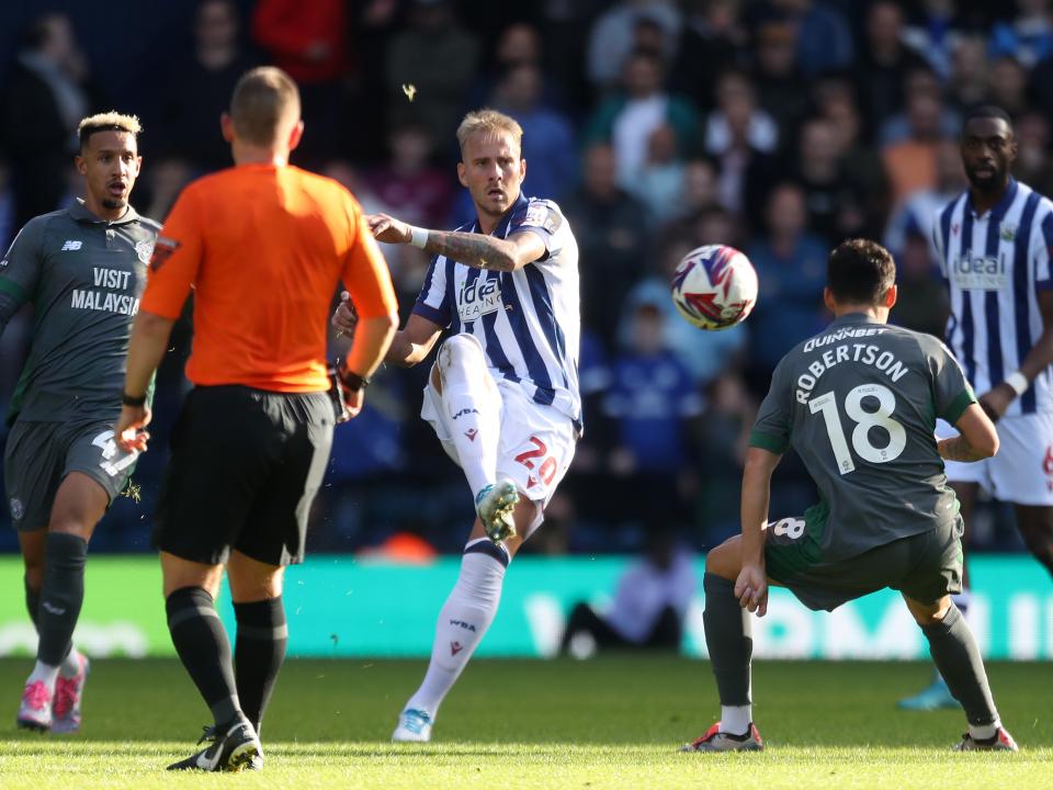 An image of Uros Racic passing the ball against Cardiff