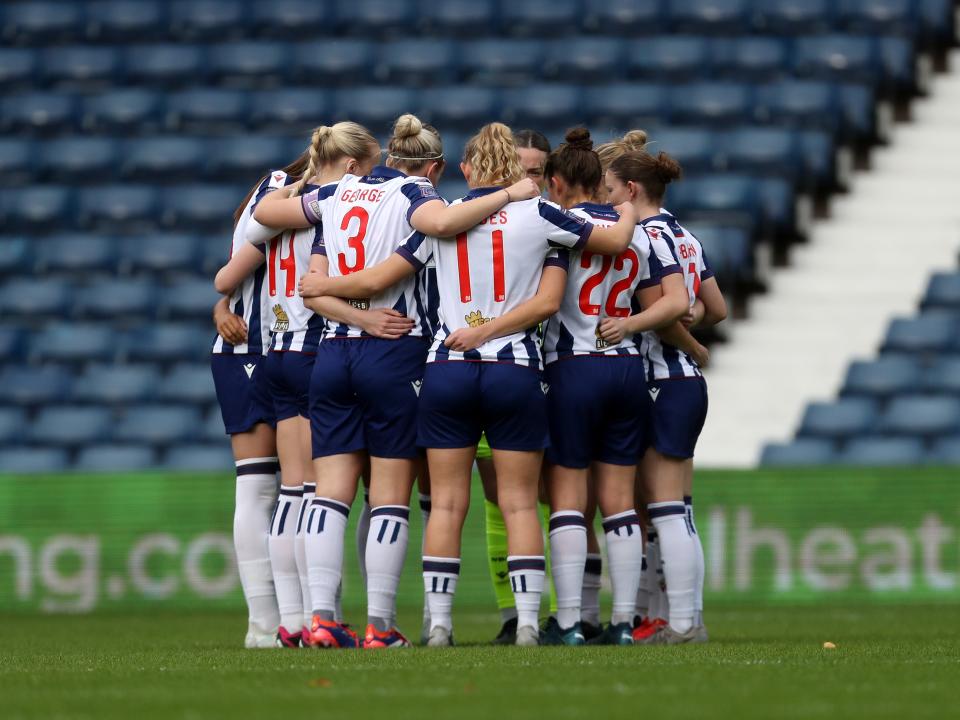 An image of Albion Women in a team huddle before their match against Wolves at The Hawthorns