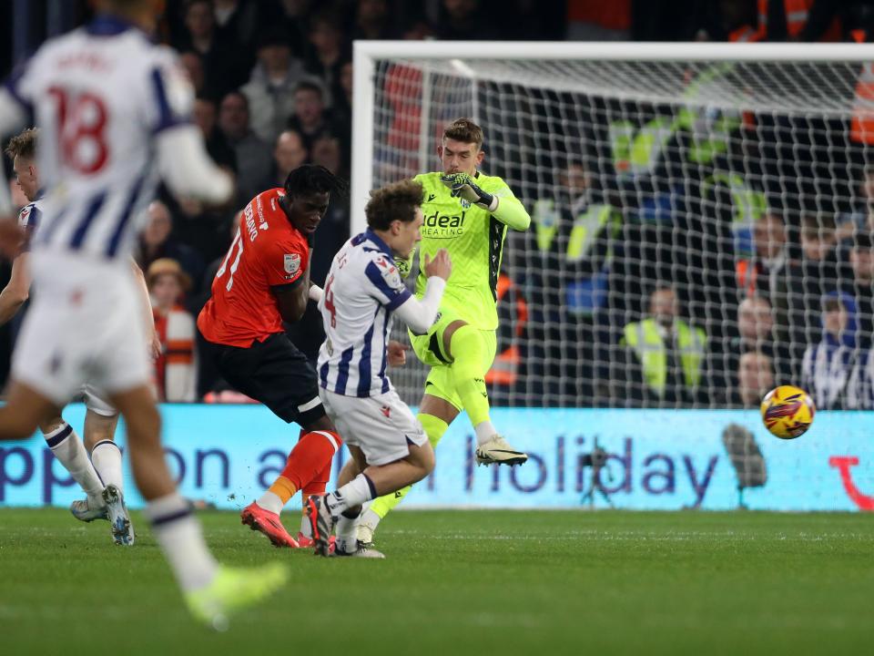 Alex Palmer clearing the ball under pressure at Luton 