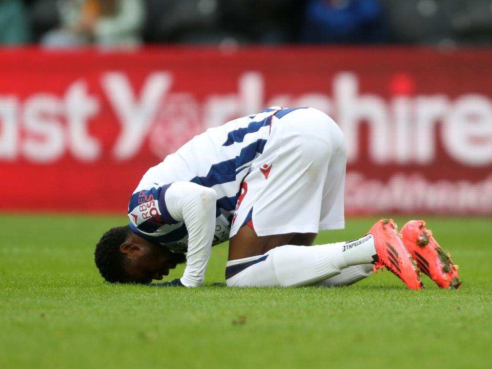 Josh Maja celebrates scoring against Hull by crouching down on the floor with his head in the grass
