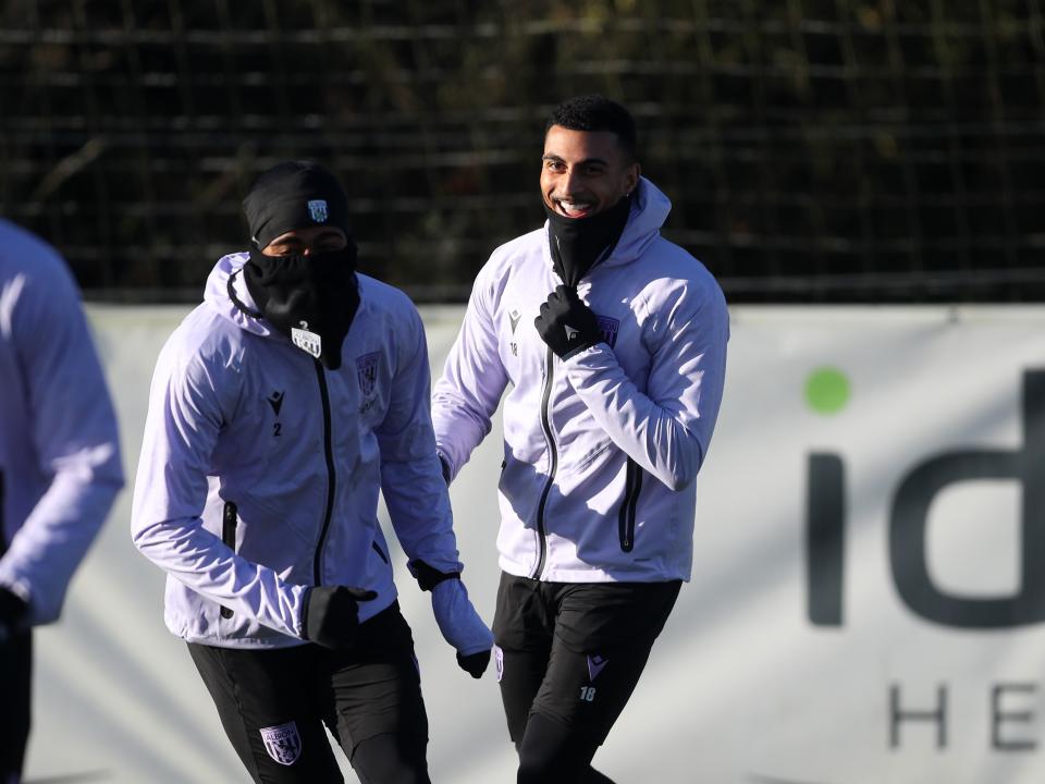 Karlan Grant and Darnell Furlong laughing during a training session 