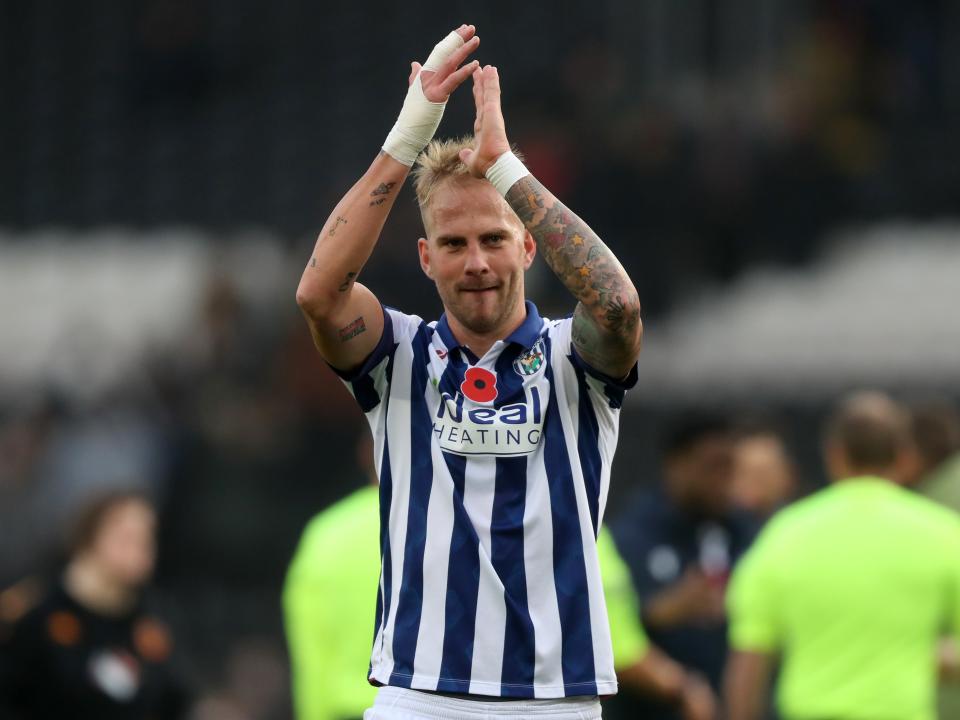 Uroš Račić applauds Albion fans at full-time at Hull
