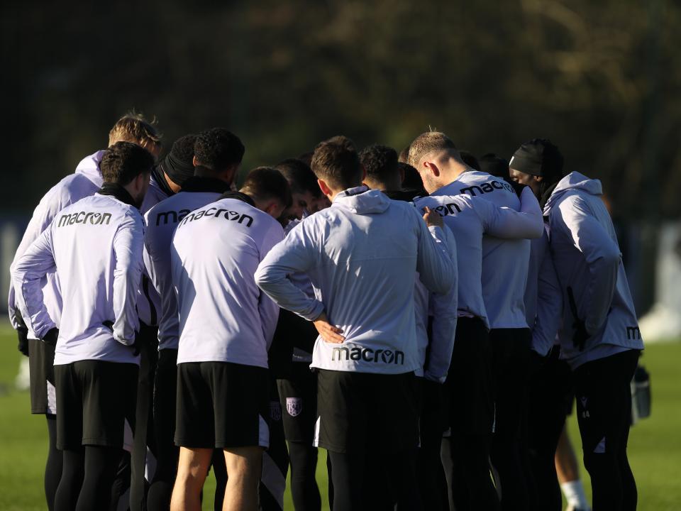 A group of Albion players in a huddle during training 