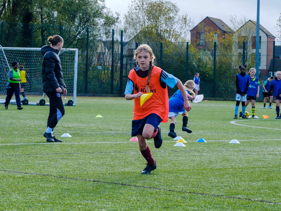 Participant running with cone in hand.