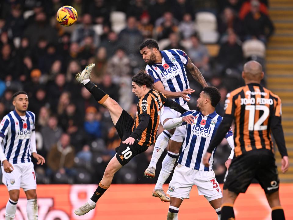 Several Hull and Albion players battle for the ball in the air