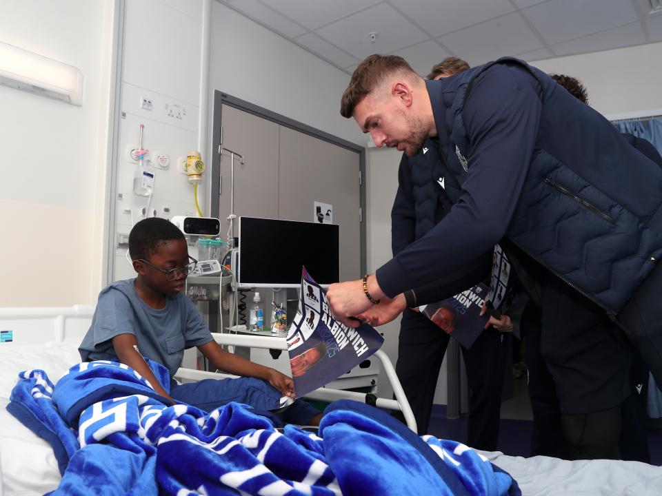 Alex Palmer speaks with a young patient at Midlands Metropolitan University Hospital 