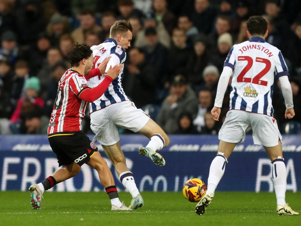 Torbjørn Heggem battling for the ball against Sheffield United in the home kit 