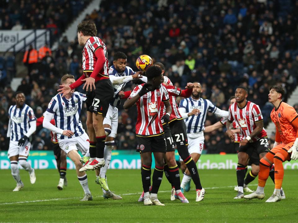Several players try and win a header for Albion and Sheffield United 