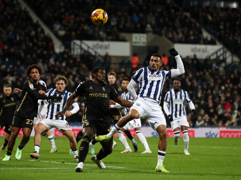 Several players try and make contact with the ball in the penalty area 