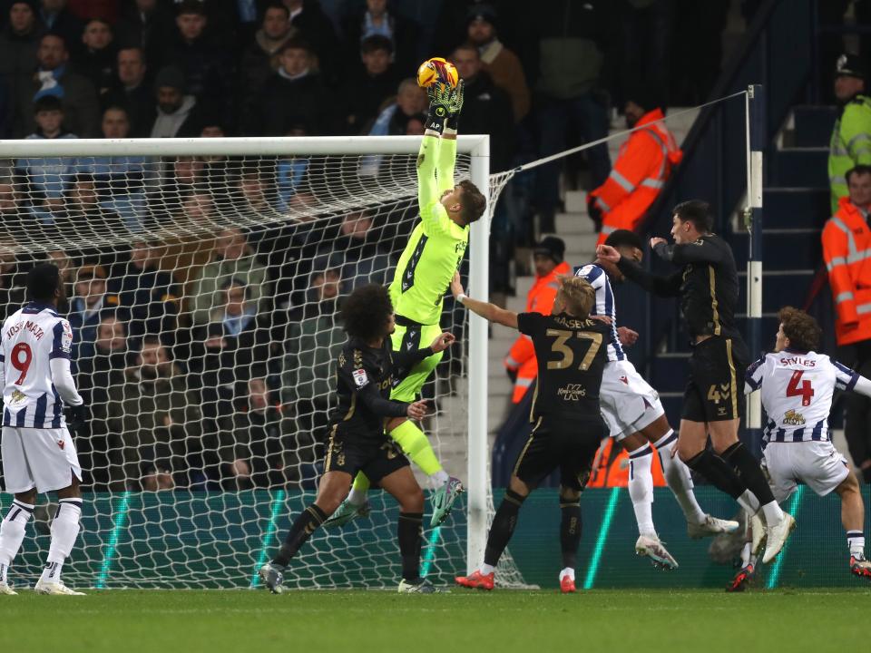 Alex Palmer catching a high ball with several players around him 