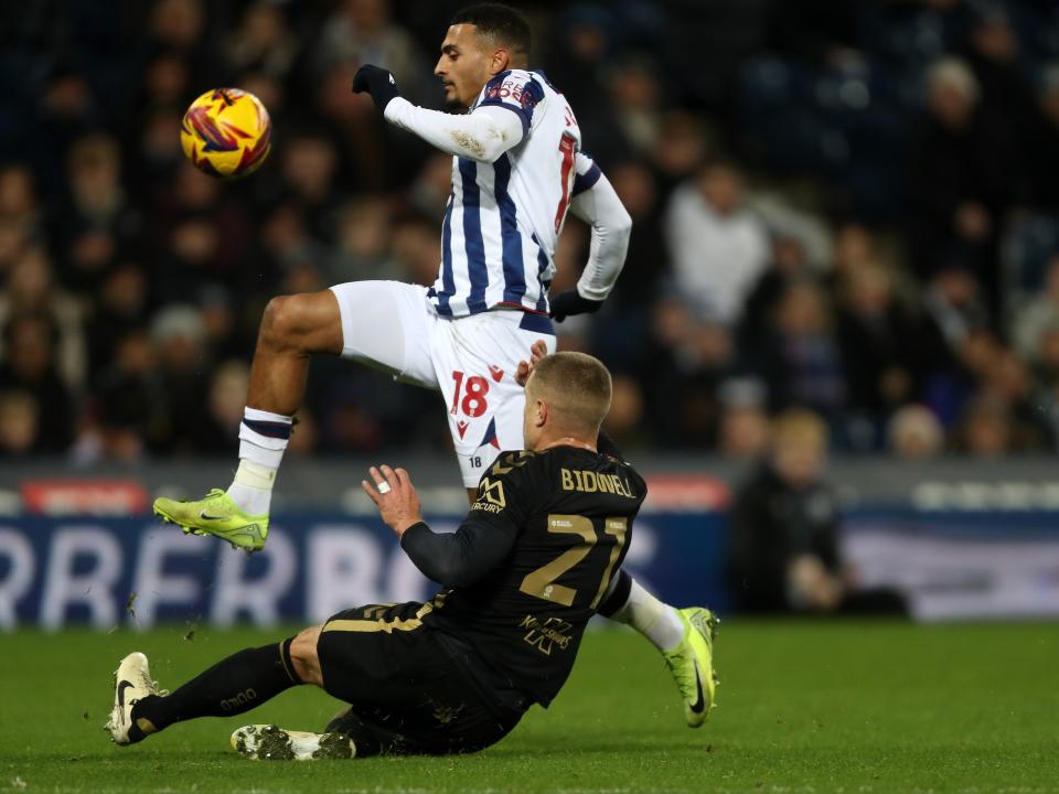 Karlan Grant is tackled by a Coventry City player 