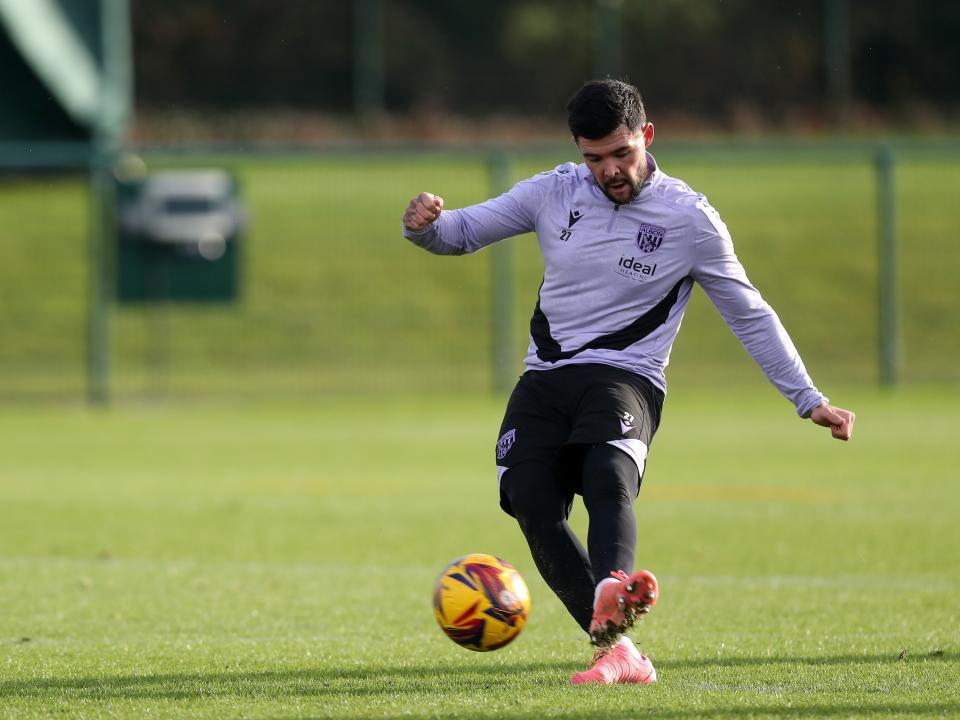 Alex Mowatt striking the ball during training 