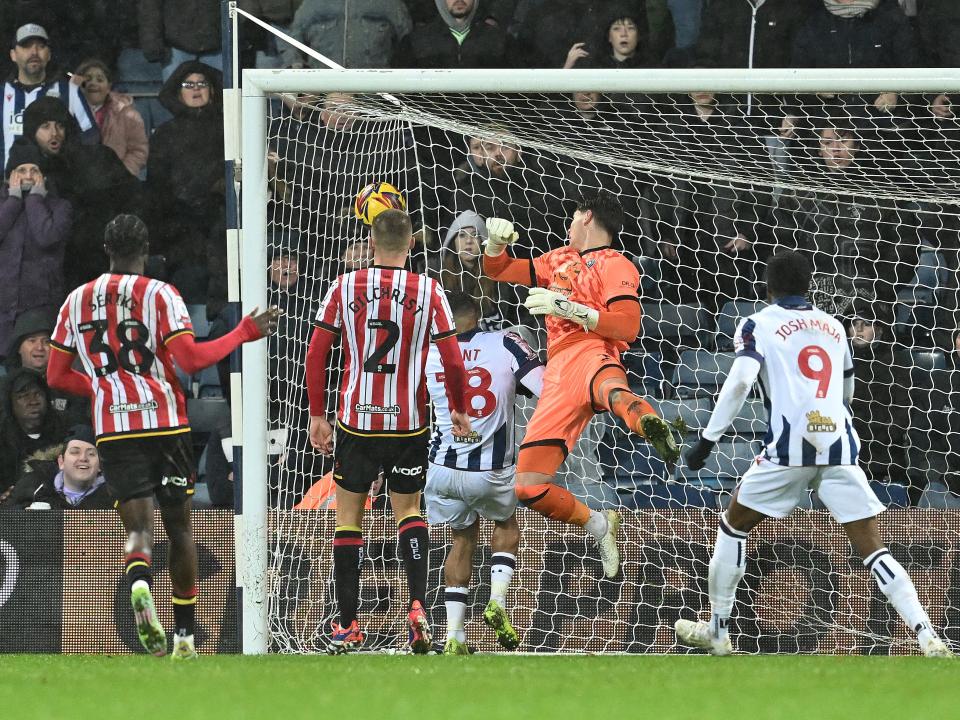 Tom Fellows' shot goes over the Sheffield United goalkeeper into the far corner 