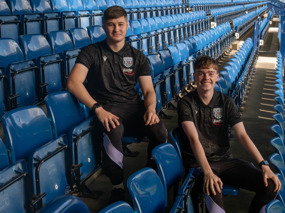 Brandon and Josh standing in the stands.