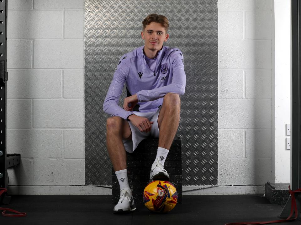 Isaac Price sat down with one foot on a yellow ball