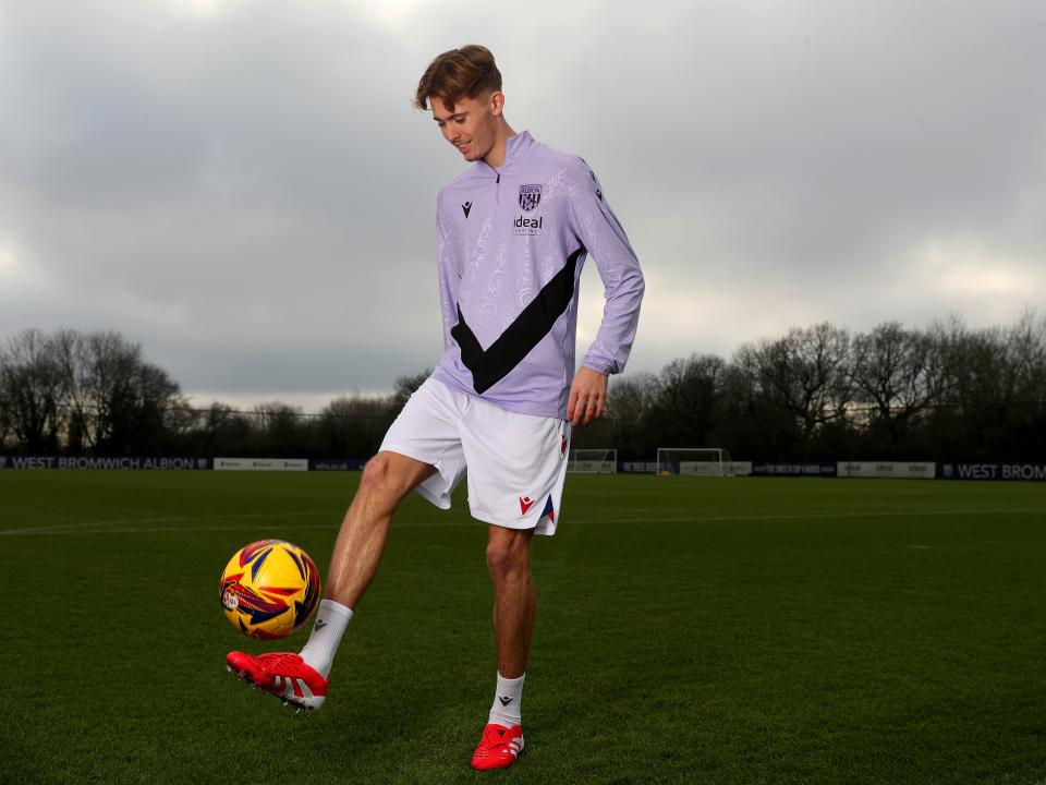 Isaac Price doing kick-ups with a yellow ball