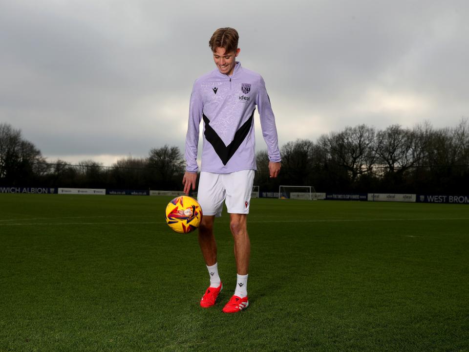 Isaac Price doing kick-ups with a yellow ball