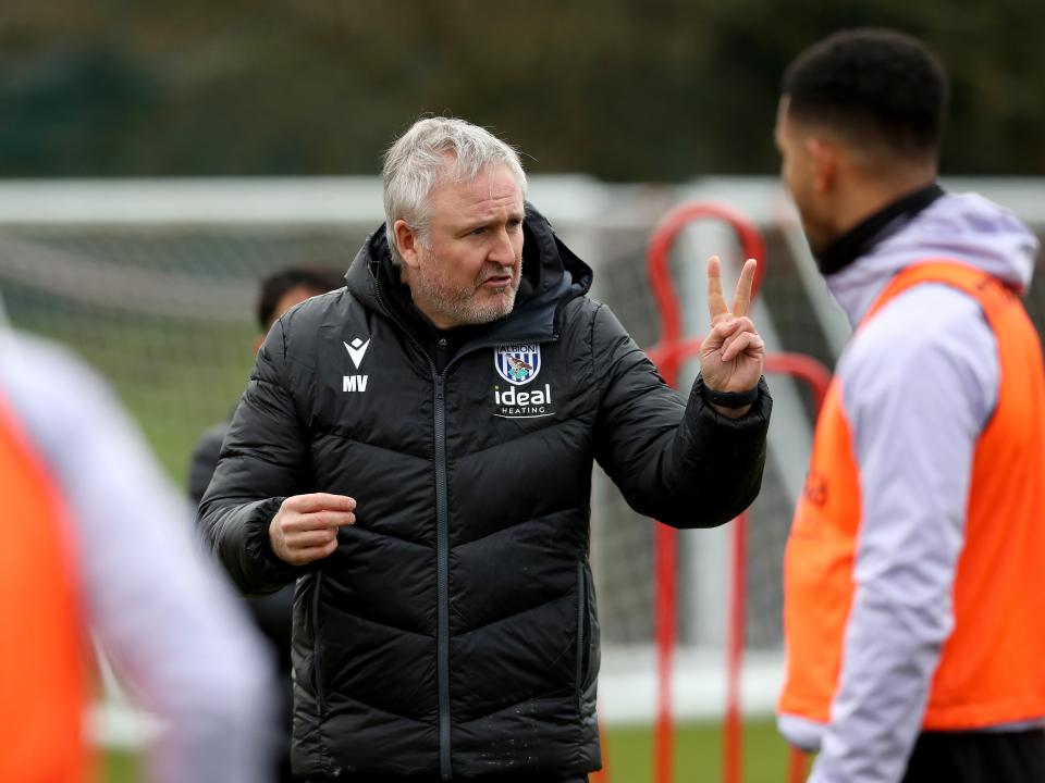 First team assistant head coach Mark Venus chatting to players on the training pitch