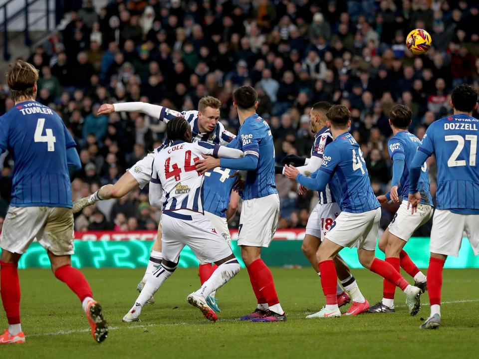 Plenty of Albion and Portsmouth players battling for the ball in the penalty area