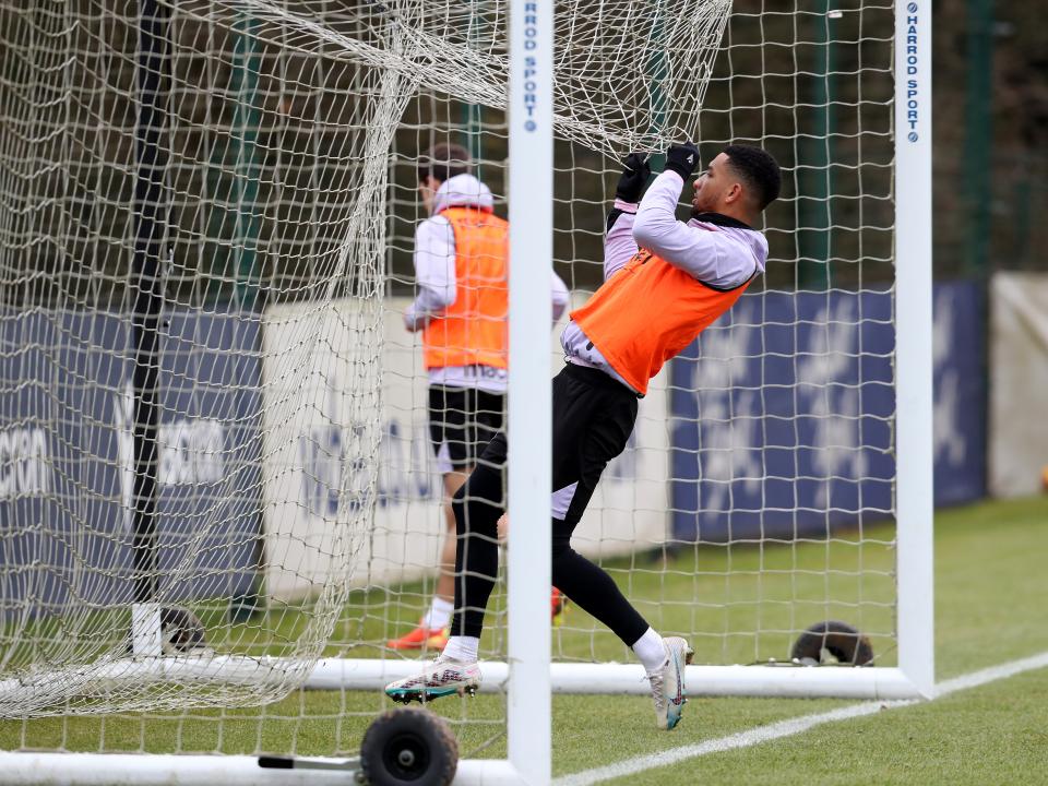 Mason Holgate hanging off a net during a training session