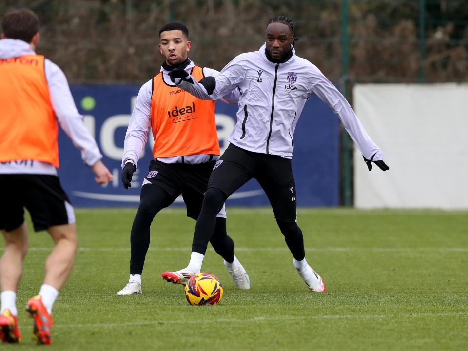 Devante Cole and Mason Holgate battling for the ball during a training session