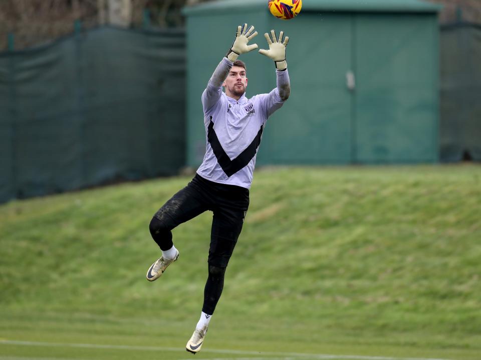 Alex Palmer catching the ball during a training session