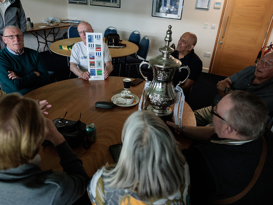 Memories Group in discussion with replicate FA Cup on the table.